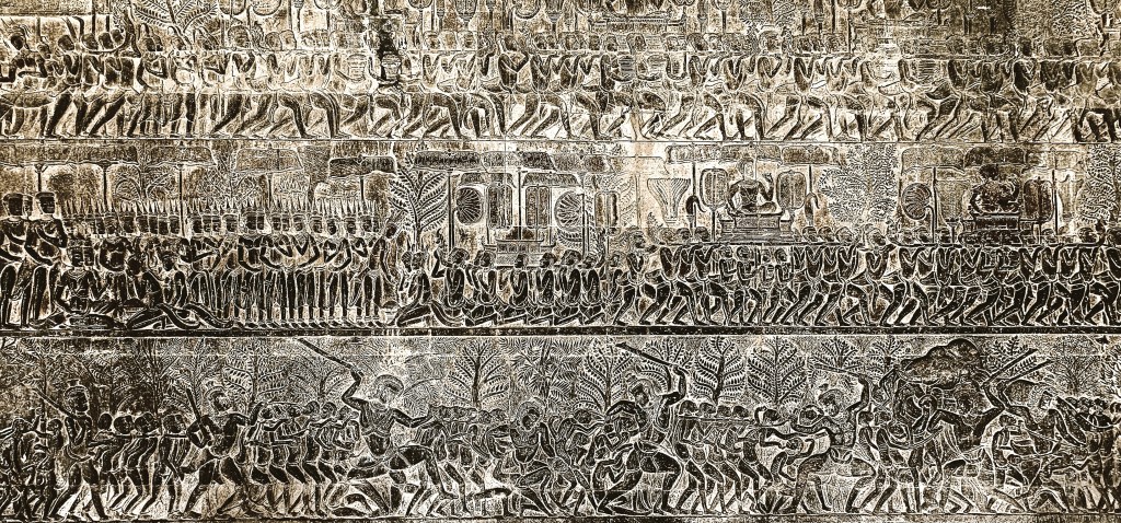 Intricate bas-relief carvings depicting a historical battle scene, showcasing detailed figures and intricate designs, part of the Angkor Wat temple complex in Cambodia.